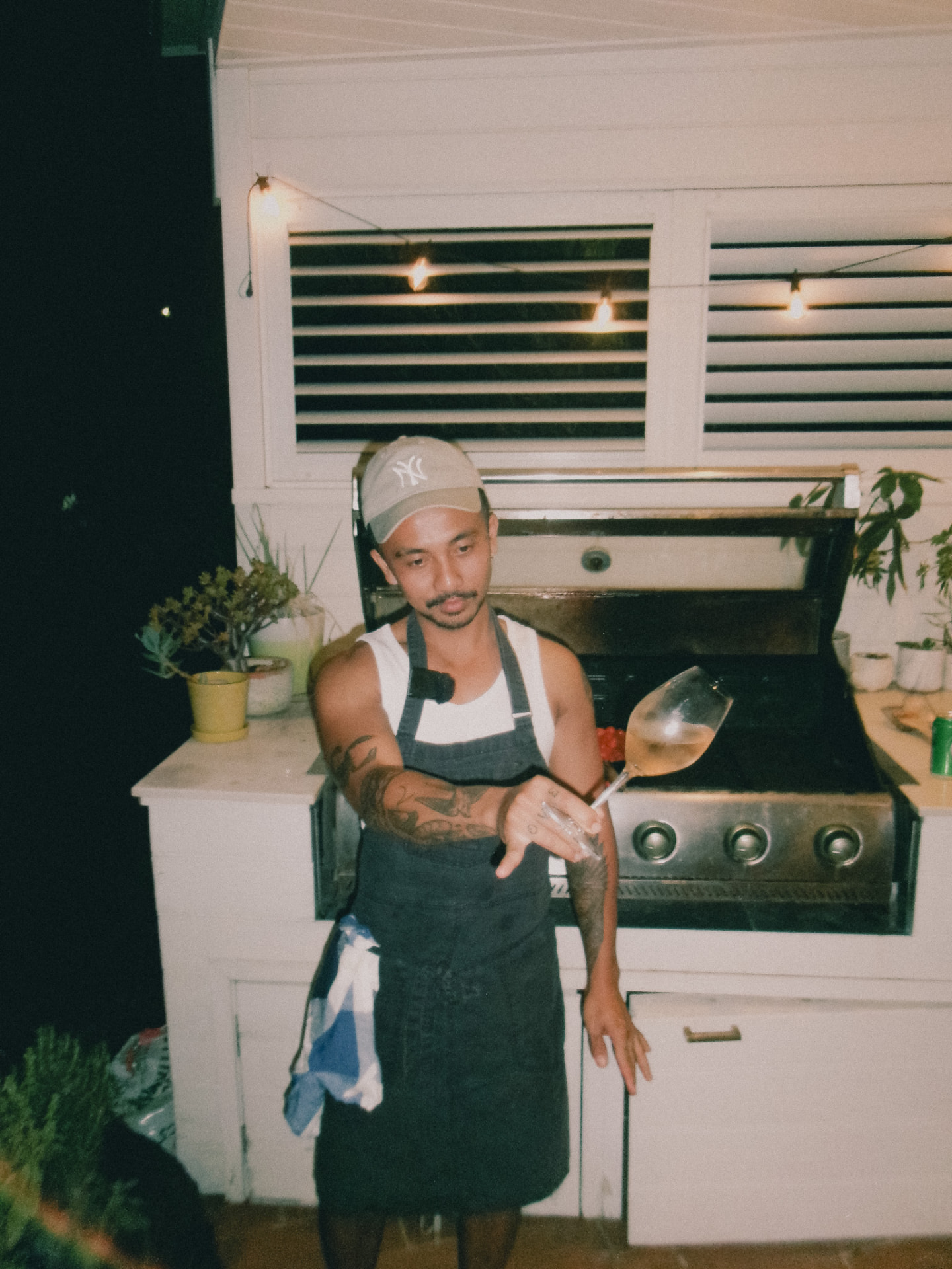 The Boy at the grill, glass raised