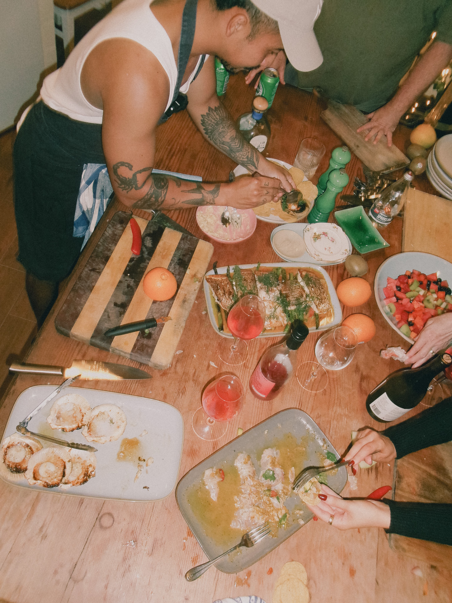 The table mid-service, hands reaching in